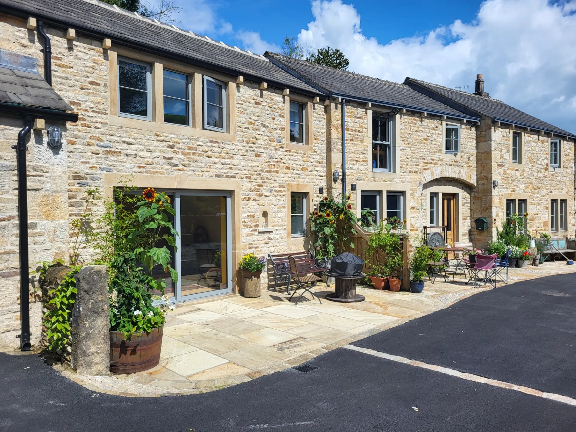a stone building with potted plants in front of it
