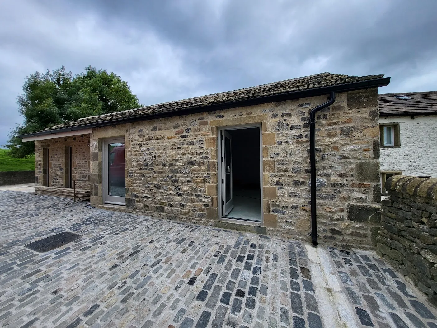 a small brick building with a door and windows