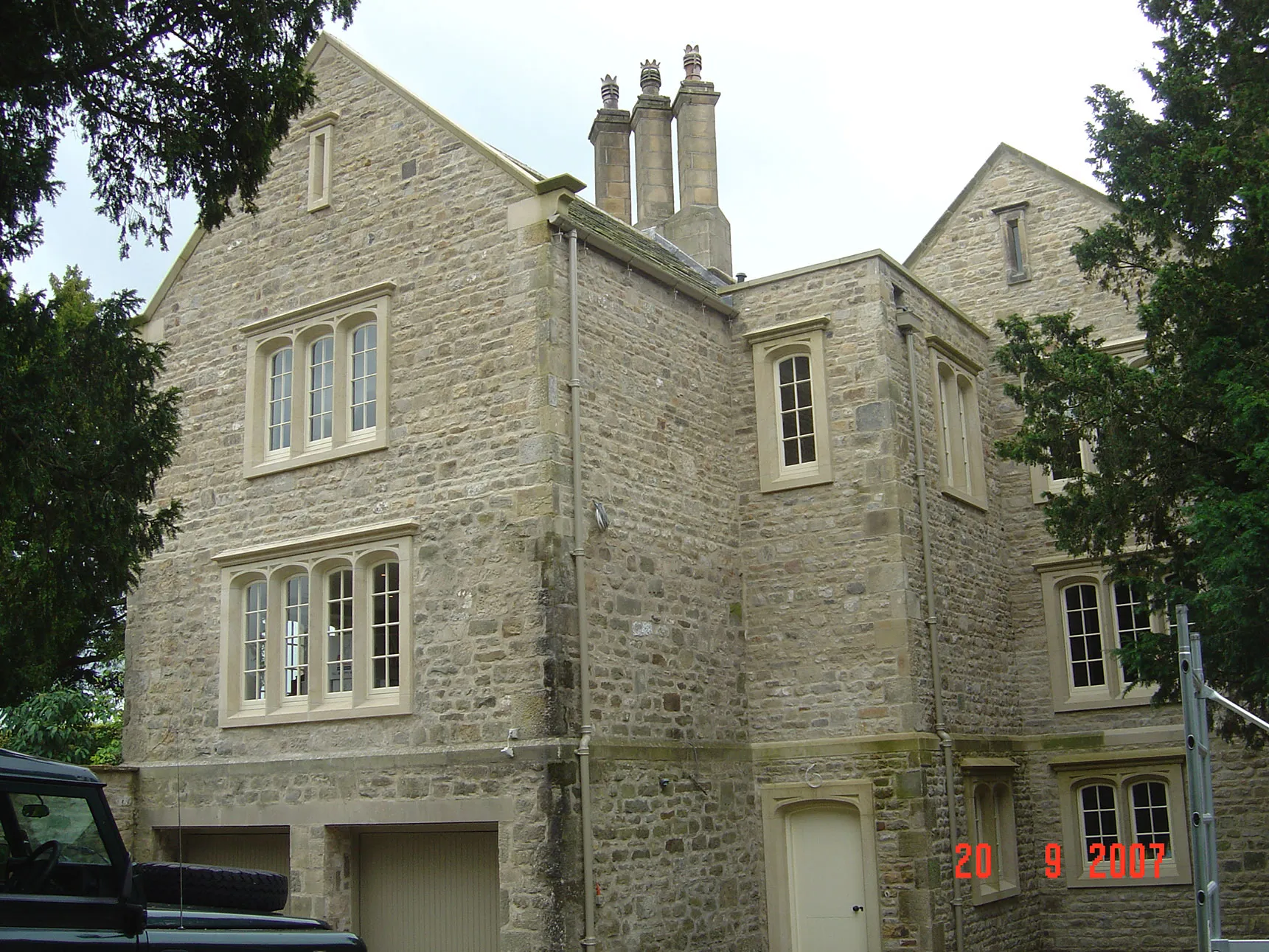 a black truck parked in front of a large brick building