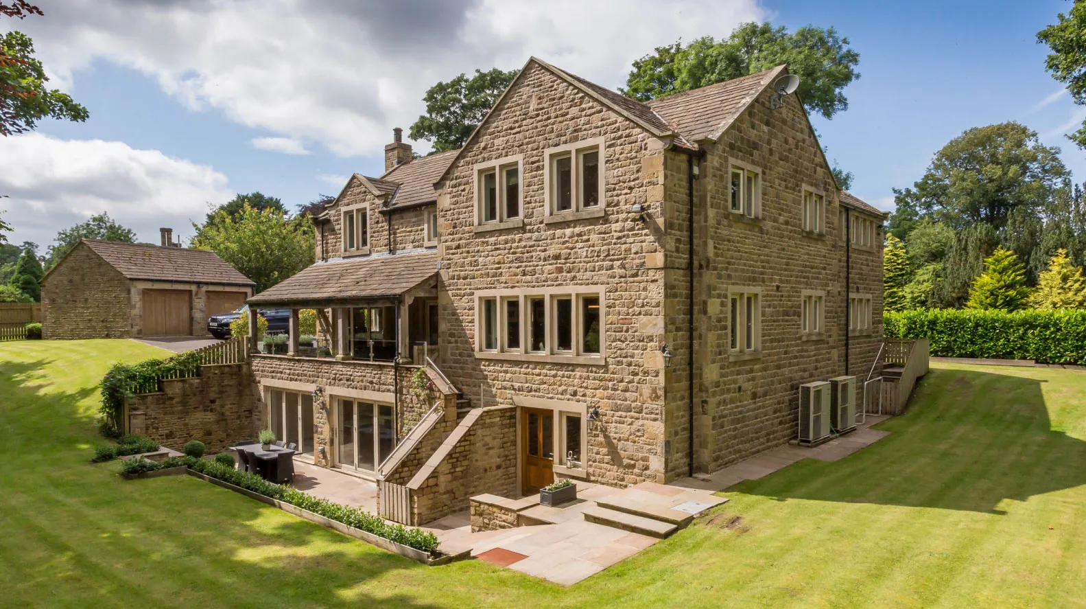 a large brick house with a large lawn in front of it