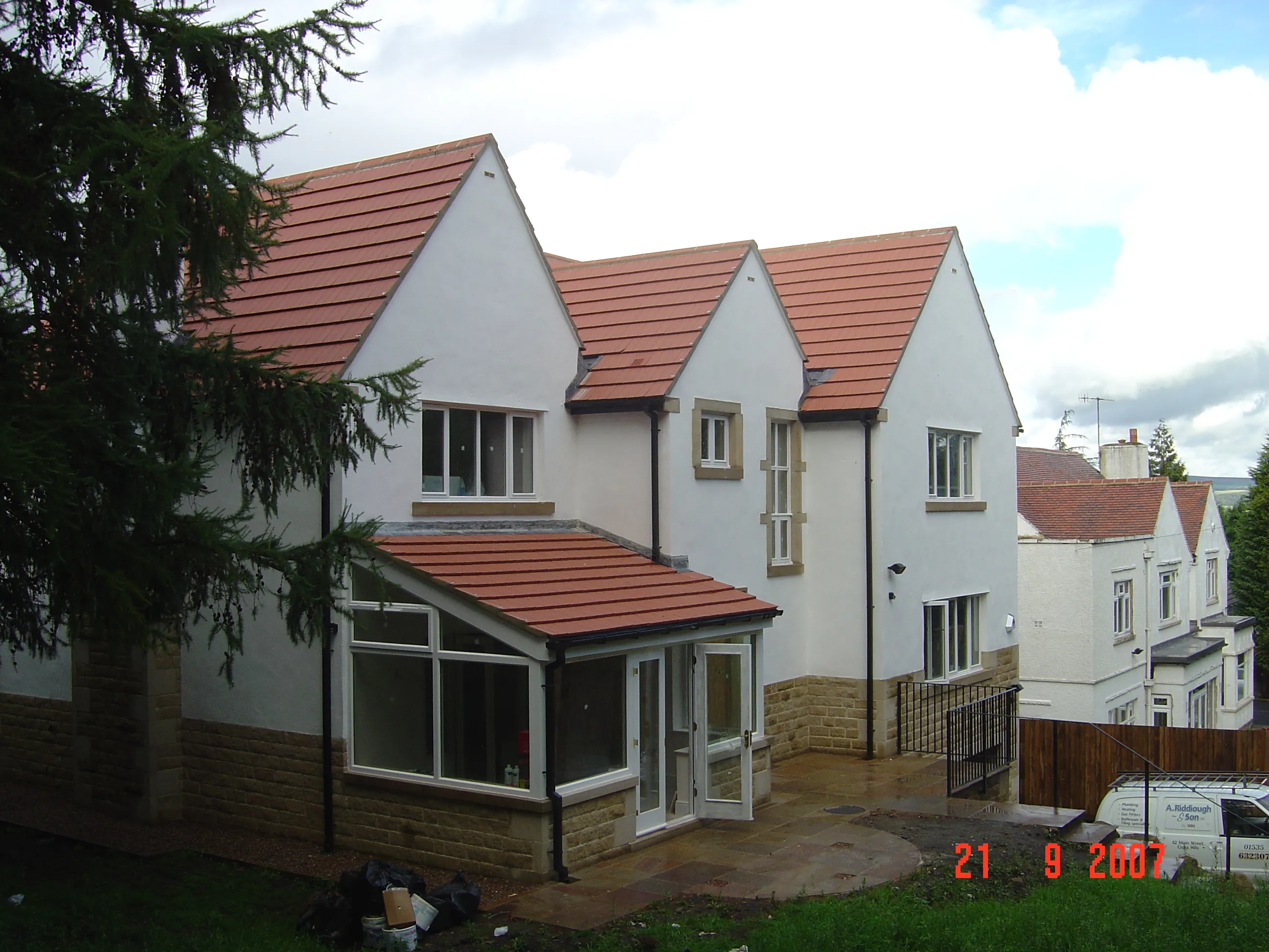 A large white house with a red roof.
